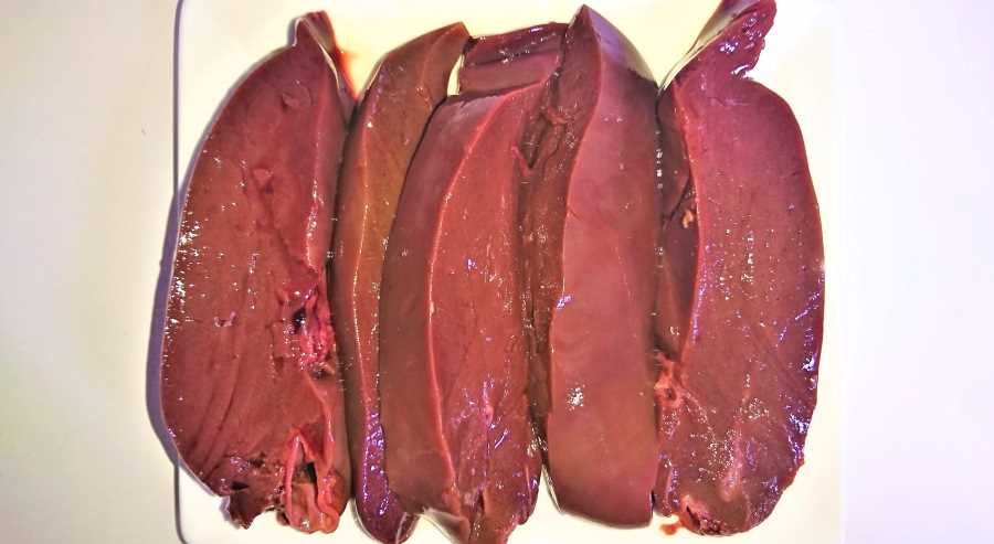 Slices of raw lamb liver on a plate