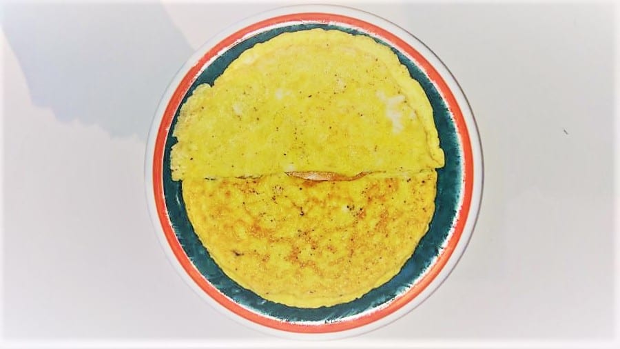 Two large egg and cheese pancakes on a plate