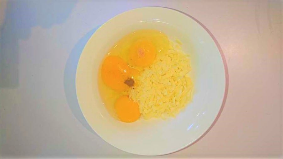 Raw eggs and grated cheese with cinnamon