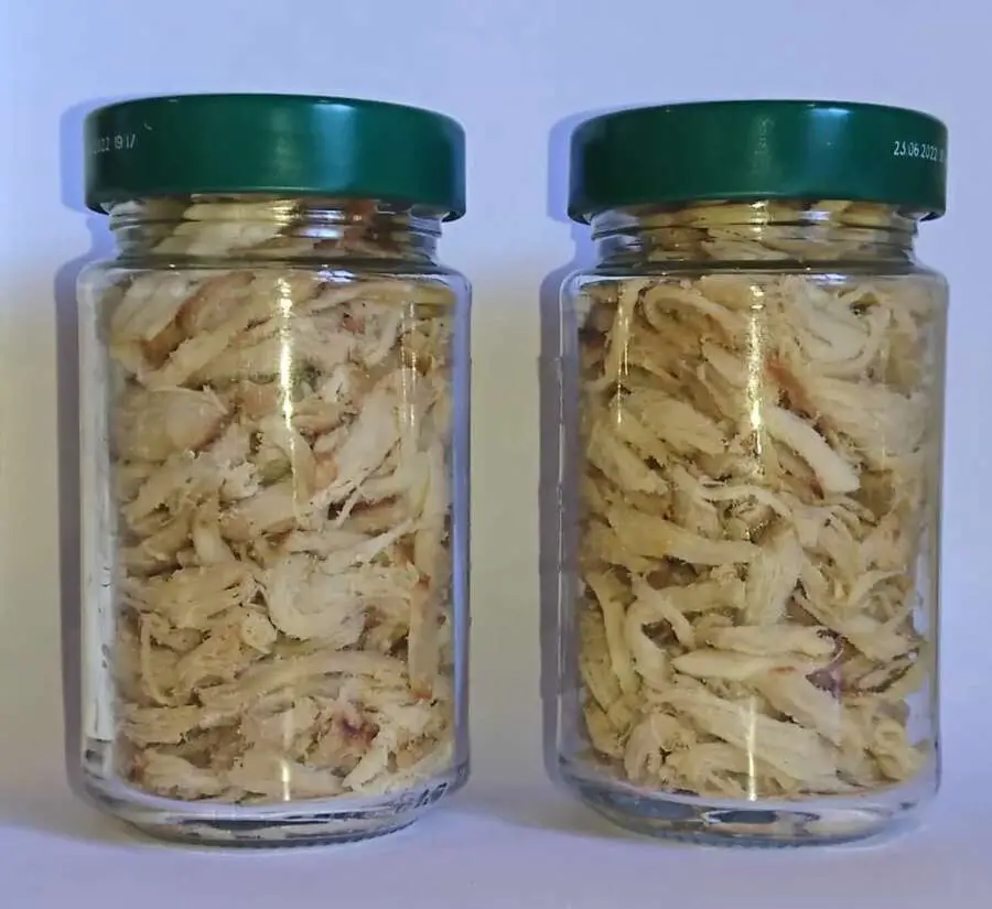 two jars of cooked shredded chicken