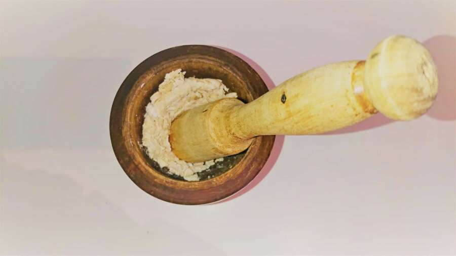 a mortar and a pestle with shredded chicken inside