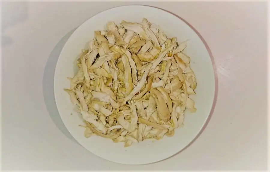 a bowl of shredded chicken pieces