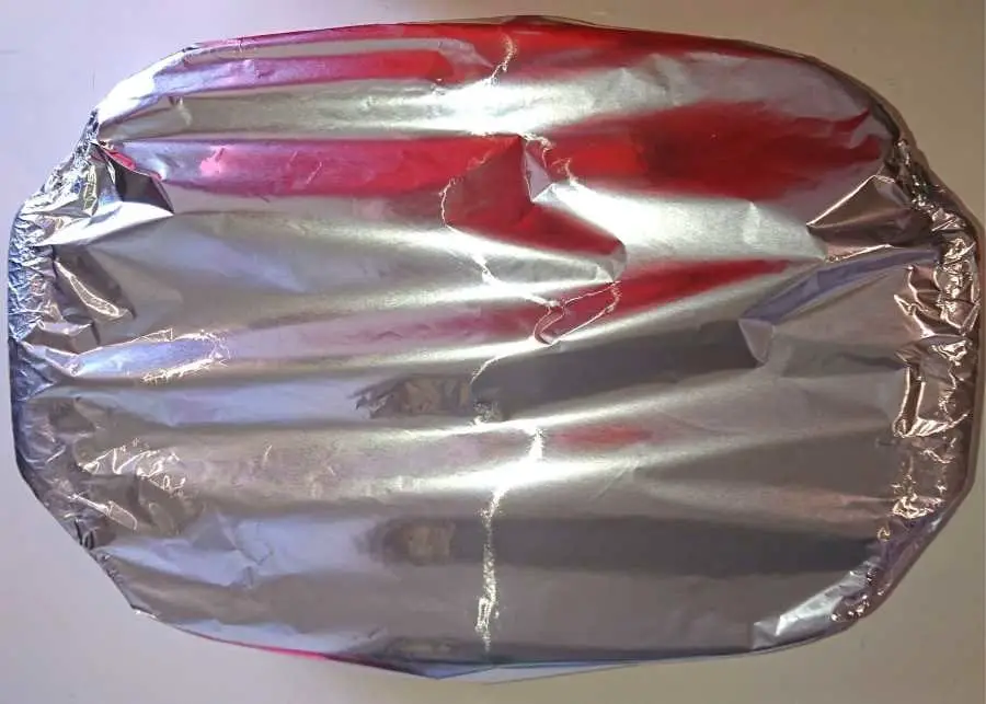 Lamb ribs in baking dish wrapped in foil
