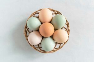 A basket of colorful eggs which are considered high in cholesterol