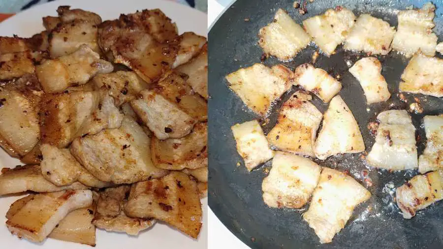 fried pork belly pieces on a plate and in a frying pan