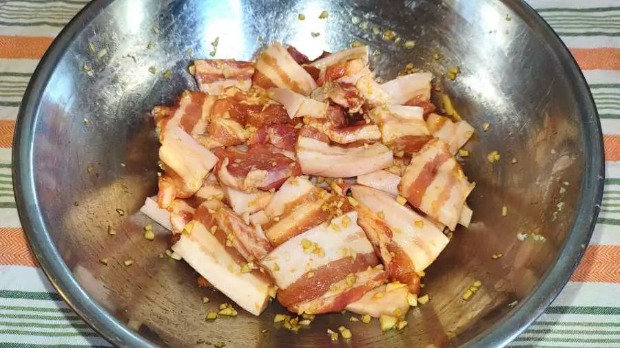 Pork belly slices being marinated