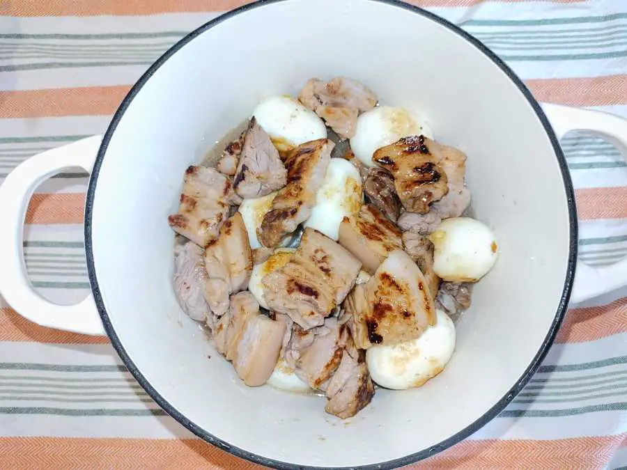 fried pork belly and egss in a pot
