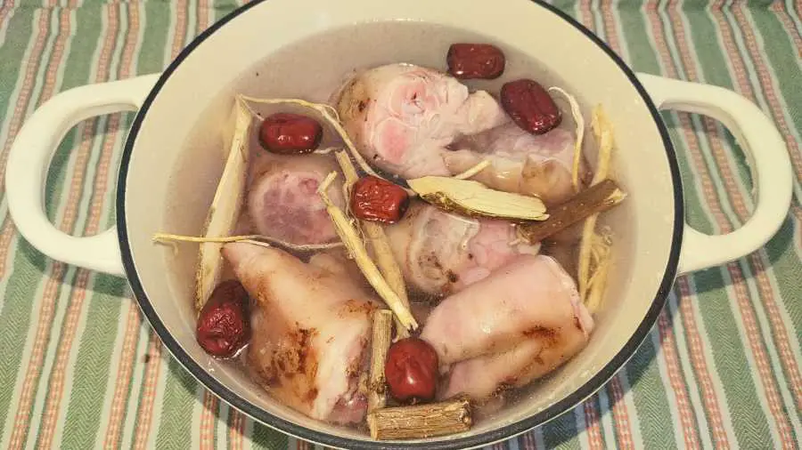 pig trotters and herbs in a pot