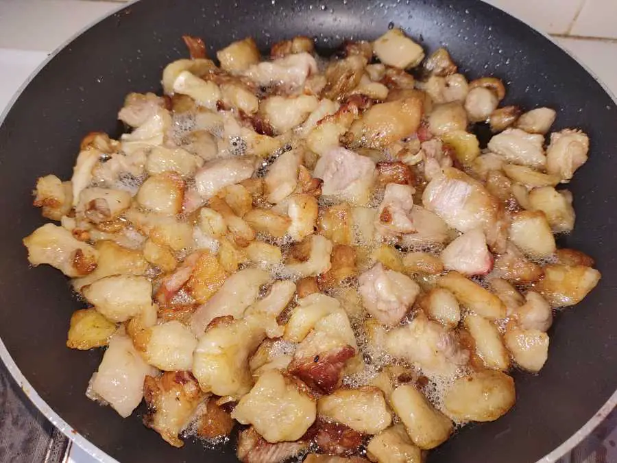 Beef tallow being rendered in a frying pan