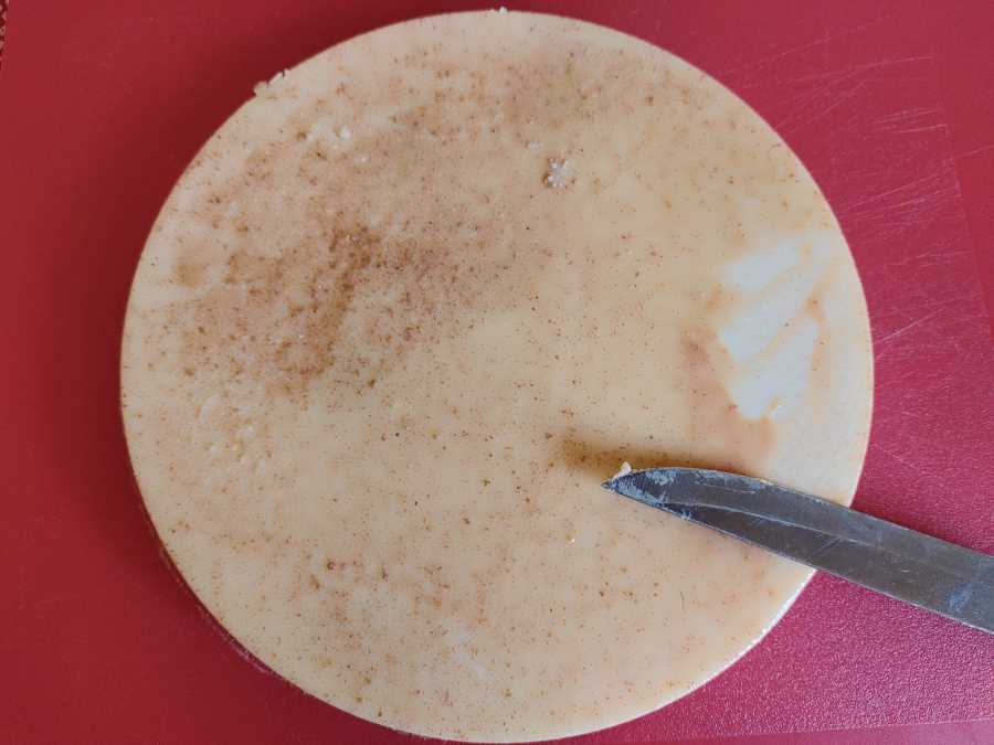 A chunk of solid beef tallow on a chopping board