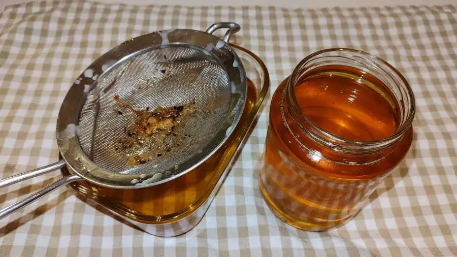 rendered beef fat in a jar and a glass container