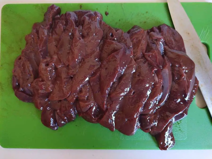 slices of beef liver on a chopping board