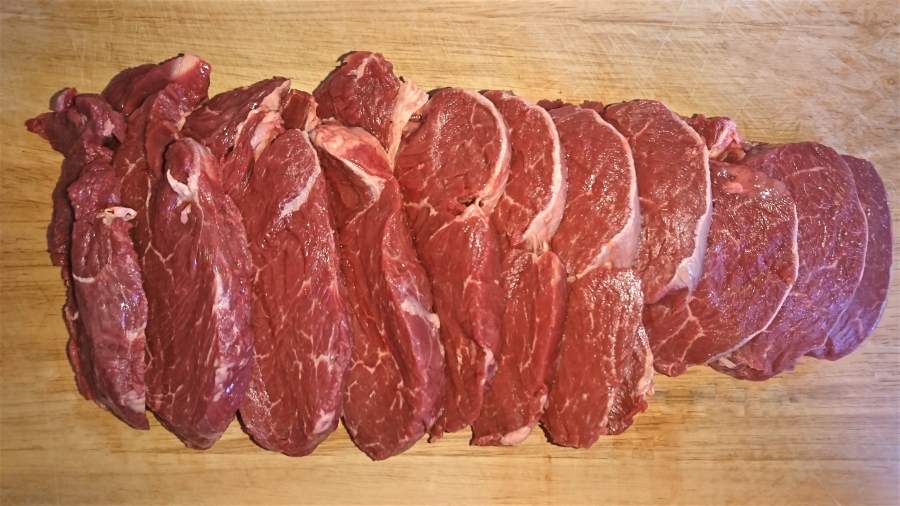 Beef tenderloin (aka eye fillet) steaks on a chopping board 